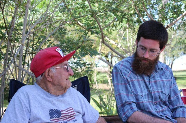 A student listens to the stories of a farmworker.